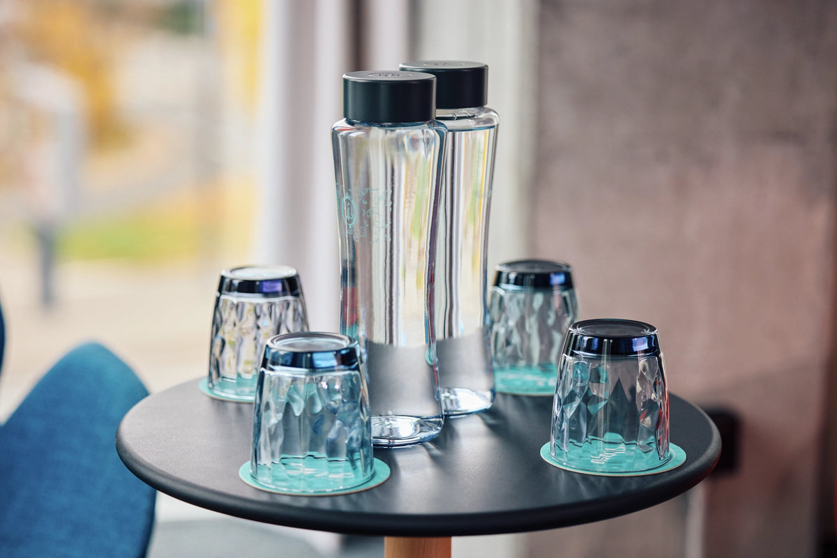 BRITA Twist bottles standing on a table with glasses