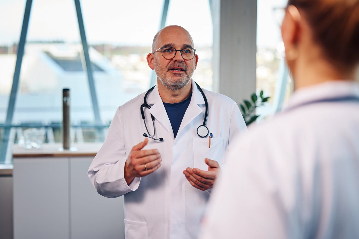 Doctor in a hospital explaing something to another person